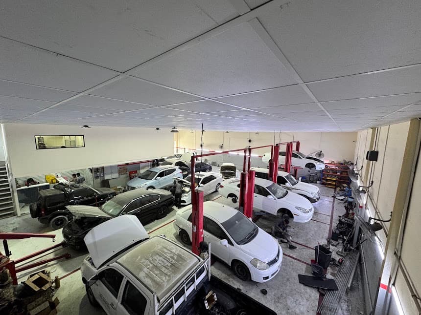 Service bays at Al Sulaiman Garage with vehicles on lifts
